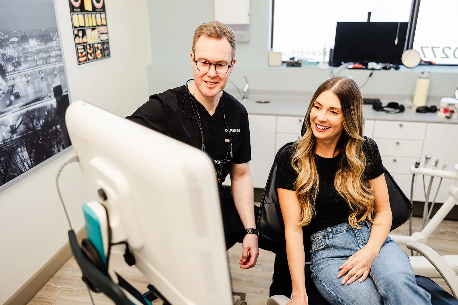 A dentist and patient reviewing imaging together