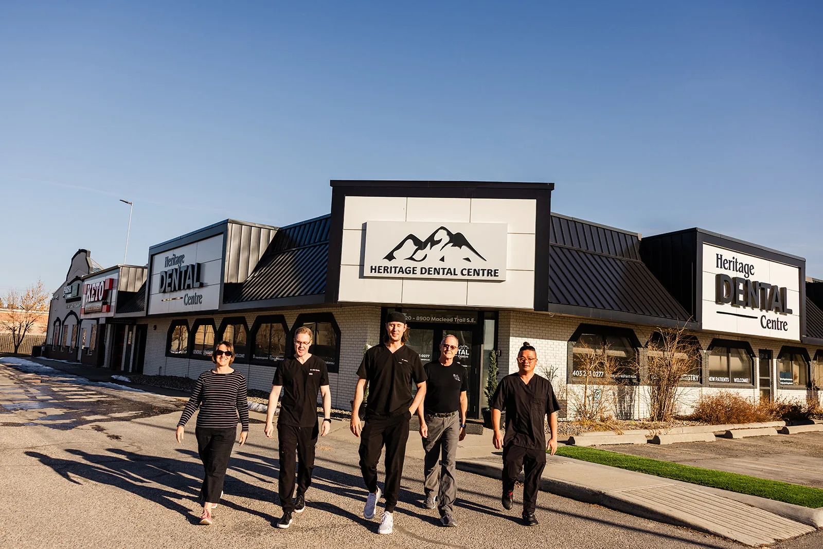 The Heritage Dental Centre team outside the practice at 8900 Macleod Trail SE, Calgary