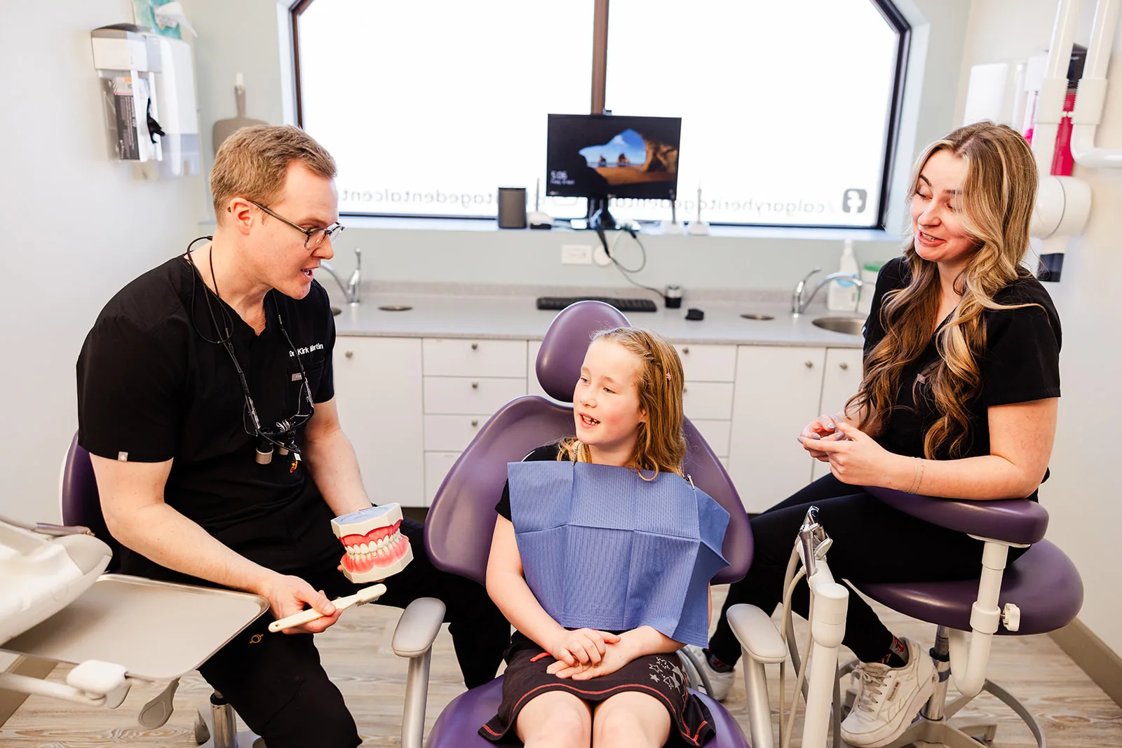 A young patient smiling in the dental chair