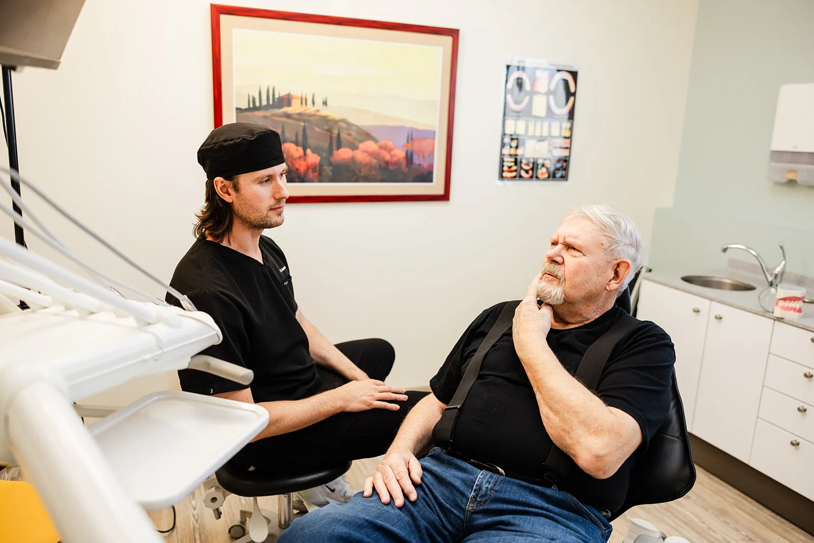 An older patient in consultation with a dentist
