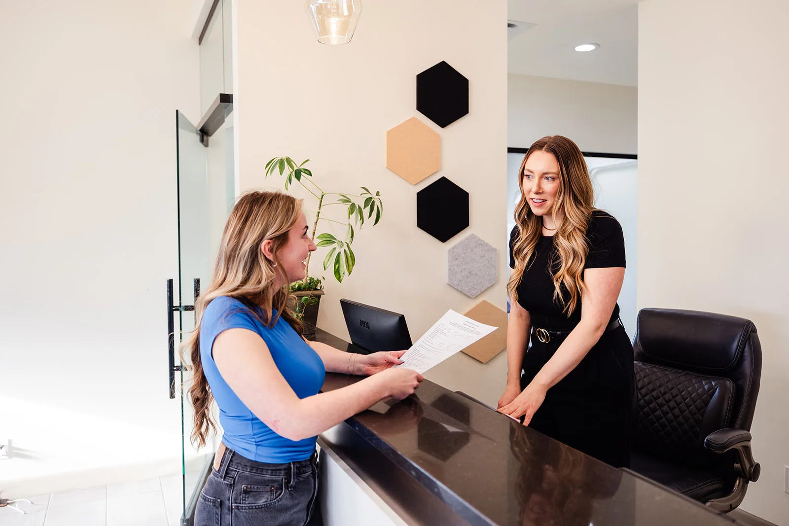 A patient being welcomed at the Heritage Dental Centre front desk