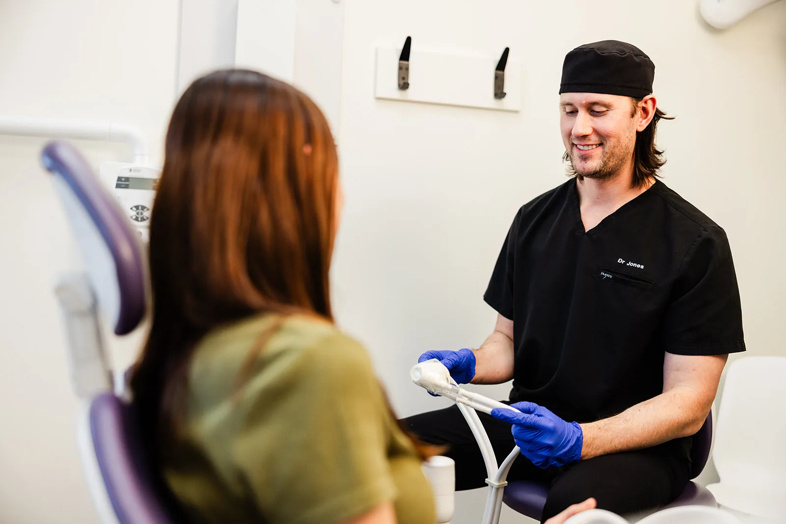 A dentist explaining nitrous oxide sedation to a patient